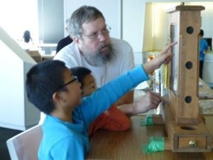 Microsoft employee and PSBA trustee Mark Hohn chats w/ kids about bees at fundraising event 2013.